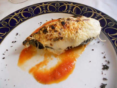 Aubergine stuffed with seafood with a cheese topping